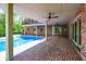 This covered patio provides a beautiful view of the pool and backyard. Includes ceiling fans and a brick floor at 8602 Frontgate Ln, Indianapolis, IN 46256