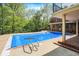 The back of this house features a covered pool with a diving board and a brick patio at 8602 Frontgate Ln, Indianapolis, IN 46256