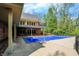 The back of this house features a covered pool with a diving board and a brick patio at 8602 Frontgate Ln, Indianapolis, IN 46256