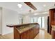 Entertain in style with this wet bar featuring marble countertop and wood cabinets at 8602 Frontgate Ln, Indianapolis, IN 46256