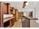 Stylish wet bar with wooden cabinetry, marble countertop, and a brick accent wall at 8602 Frontgate Ln, Indianapolis, IN 46256