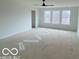 Large bedroom with ceiling fan and ample natural light from the windows at 9497 Dogwood Dr, McCordsville, IN 46055
