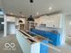 Spacious kitchen with white cabinets, a large island, and modern pendant lighting at 9497 Dogwood Dr, McCordsville, IN 46055