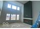 Dramatic living room featuring large windows, a tall fireplace, and high ceilings at 9497 Dogwood Dr, McCordsville, IN 46055
