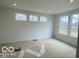 Open living space with large windows, a neutral color palette, and recessed lighting at 9497 Dogwood Dr, McCordsville, IN 46055