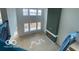 Bright living room featuring a fireplace, large windows, and high ceilings at 9497 Dogwood Dr, McCordsville, IN 46055