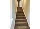 Carpeted staircase leading to the upper level, offering comfort and safety at 1078 Tomahawk Pl, Martinsville, IN 46151