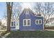 Blue house with a grassy yard and front porch at 1103 W 5Th St, Anderson, IN 46016