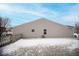 Tan house with a snow-covered backyard and wooden fence at 1710 Elderberry Dr, Indianapolis, IN 46234