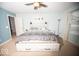 Main bedroom with king bed, ceiling fan and window at 1710 Elderberry Dr, Indianapolis, IN 46234