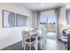Modern dining area with a gray table and six white chairs at 18655 Moray St, Westfield, IN 46069