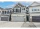 Two-story townhome with gray and white siding, gray garage door, and a brick base at 18655 Moray St, Westfield, IN 46069