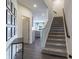 Bright foyer with dark hardwood floors and staircase at 18655 Moray St, Westfield, IN 46069
