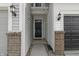 Front entry with navy blue door, brick columns, and a wreath at 18655 Moray St, Westfield, IN 46069