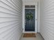 Front entry with navy blue door, wreath, and welcome mat at 18655 Moray St, Westfield, IN 46069