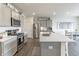Open kitchen features stainless steel appliances and an island at 18655 Moray St, Westfield, IN 46069