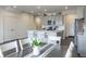 Kitchen with white and gray cabinets, island, and dining area at 18655 Moray St, Westfield, IN 46069