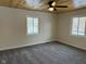 Bright bedroom with ceiling fan, neutral walls, and grey carpeting at 1908 N Duane Rd, Muncie, IN 47304