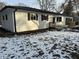 Side view of a white ranch home with a wooden deck and snow on the ground at 1908 N Duane Rd, Muncie, IN 47304