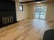 Living room with fireplace, sliding glass doors to backyard, and wood-look flooring at 1908 N Duane Rd, Muncie, IN 47304