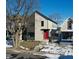 Modern two-story home with a red door and snow-covered lawn at 2009 Carrollton Ave, Indianapolis, IN 46202