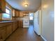 Kitchen with wood cabinets, tile floor and white appliances at 2104 Drexel Dr, Anderson, IN 46011