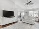 Living room with hardwood floors, a light gray couch, and a large window at 2240 Mozart Dr, Greenfield, IN 46140