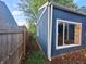 A view of the home's exterior showcasing siding and a white window trim at 2317 Fowler St, Anderson, IN 46012