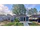 Charming home featuring a cozy front porch and complemented by mature trees against a blue sky at 2317 Fowler St, Anderson, IN 46012