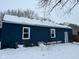 Rear view of blue house, snow covered yard at 2317 Fowler St, Anderson, IN 46012