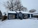 Blue house with white trim, snow covered yard at 2317 Fowler St, Anderson, IN 46012