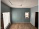 Newly painted room with new flooring and large window at 2317 Fowler St, Anderson, IN 46012