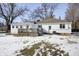 Spacious backyard with a wooden deck and snow-covered lawn at 233 S Routiers Ave, Indianapolis, IN 46219