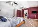 Bright bedroom featuring a bed, natural light, ceiling fan, and a TV at 233 S Routiers Ave, Indianapolis, IN 46219