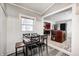 Charming dining area with wood table and chairs, adjacent to kitchen at 233 S Routiers Ave, Indianapolis, IN 46219