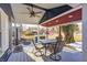 Covered porch with seating area and American flag decor at 233 S Routiers Ave, Indianapolis, IN 46219