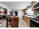 Modern kitchen with stainless steel appliances and wood cabinets at 233 S Routiers Ave, Indianapolis, IN 46219