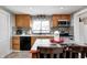 Updated kitchen boasts wood cabinets, tile backsplash, and stainless steel appliances at 233 S Routiers Ave, Indianapolis, IN 46219