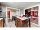 Open kitchen features island, modern appliances, and tile flooring at 233 S Routiers Ave, Indianapolis, IN 46219