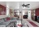 Spacious living room with gray sofa, area rug, ceiling fan and view of the kitchen at 233 S Routiers Ave, Indianapolis, IN 46219