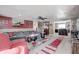 Open concept living room and kitchen, featuring a gray sectional and red accents at 233 S Routiers Ave, Indianapolis, IN 46219