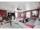 Open living room with a comfortable gray sofa, TV, ceiling fan, and decor at 233 S Routiers Ave, Indianapolis, IN 46219
