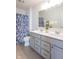 Modern bathroom with double vanity, shower, and patterned curtain at 2406 Ninebark Dr, Plainfield, IN 46168