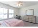 Bright bedroom with a comfortable bed, dresser, and large windows at 2406 Ninebark Dr, Plainfield, IN 46168