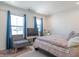 Spacious bedroom with a large bed, comfortable chair, and plenty of natural light at 2406 Ninebark Dr, Plainfield, IN 46168