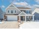 Two-story house with gray and beige siding, a white garage door, and a covered porch at 2406 Ninebark Dr, Plainfield, IN 46168