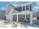Two-story house with gray and beige siding, a white garage door, and a covered porch at 2406 Ninebark Dr, Plainfield, IN 46168