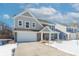 Two-story house with gray and beige siding, a white garage door, and a covered porch at 2406 Ninebark Dr, Plainfield, IN 46168