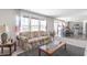 Living area with floral sofas, coffee table, and view of kitchen at 2406 Ninebark Dr, Plainfield, IN 46168