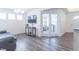 Spacious living room with gray sofa, hardwood floors and a view into home office at 2406 Ninebark Dr, Plainfield, IN 46168